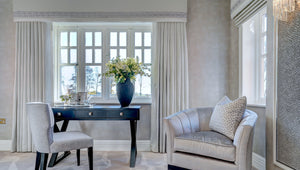 Modern home with a desk, chairs, and decorative elements.